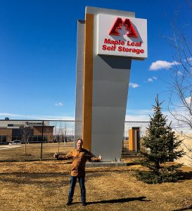 Regan in front of Country Hills Pylon Sign